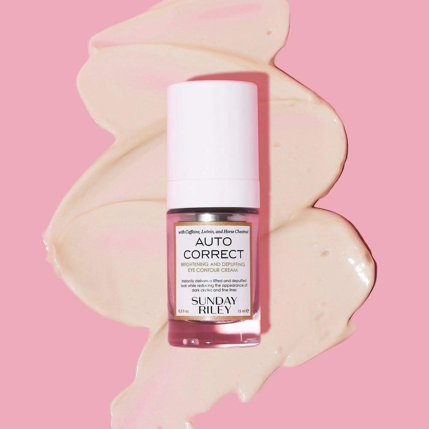 Sunday Riley Autocorrect Brightening and Depuffing Eye Contour Cream on a soft pink background, showcasing its luxurious formula.