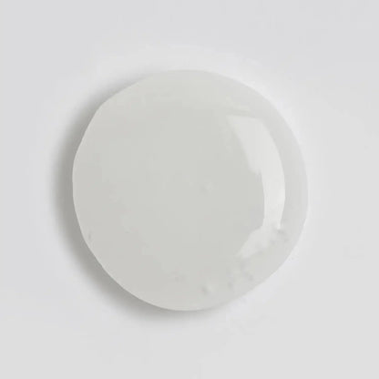 Clear, viscous drop of The INKEY List Polyglutamic Acid Serum on a white background.