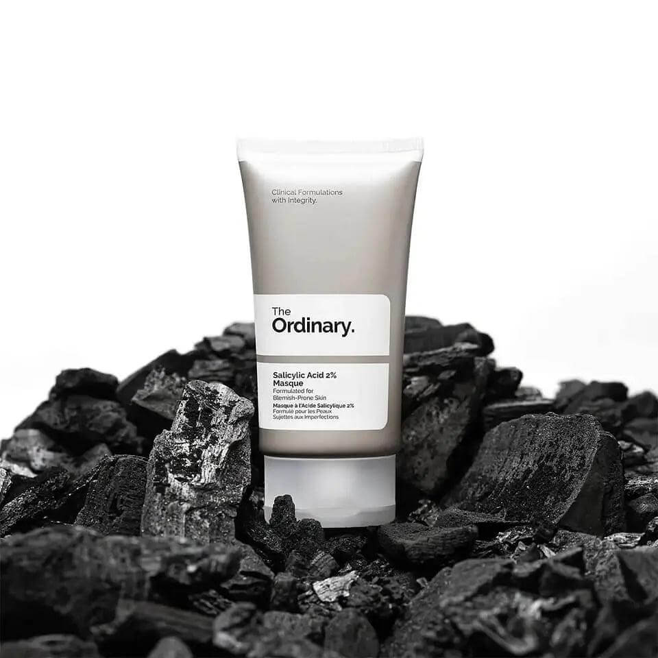 The Ordinary Salicylic Acid 2% Masque 50ml tube on a bed of charcoal, perfect for clearer skin.