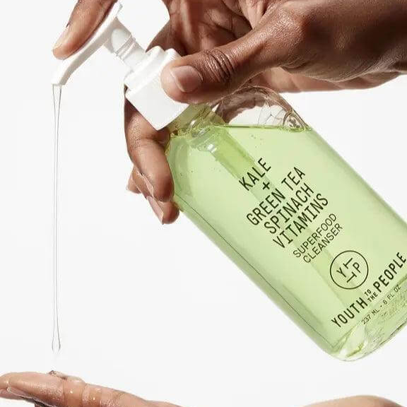 Youth To The People Superfood Cleanser with kale and green tea pouring into hand for skincare routine.